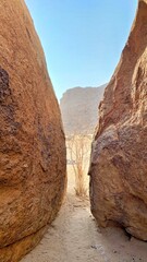 View through two granite boulders to a bush and Spitzkoppe