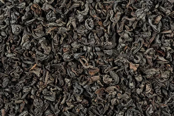 Foto op Aluminium Background of dry black tea leaves, top view. Dried black tea as background. © domnitsky