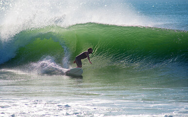 Surfer in action in the tubular waves of the Atlantic Ocean