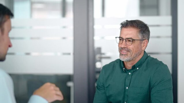 Happy business men executive partners making agreement with handshake at meeting. Company investor shaking hand of customer, client making deal in office. Getting hired at job interview concept.