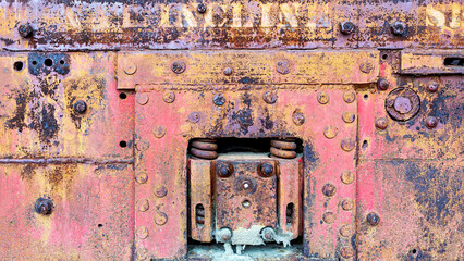Industrial mechanical metal background texture with worn and faded yellow and red paint 