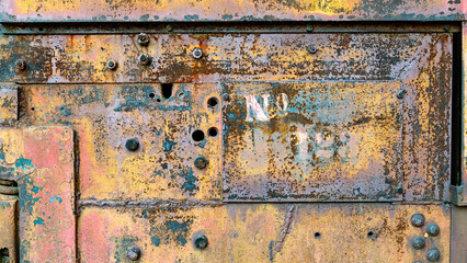 Industrial grunge rusty metal background texture with faded yellow and red paint 