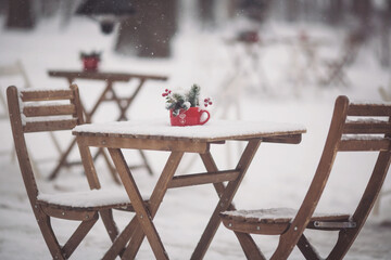 Christmas outdoor terrace with table, chairs and Christmas decorations and lights. a snowy winter...