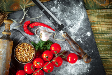 Raw pasta, spaghetti in a plate with seasonings and vegetables. Raw, ready-to-cook dish.
