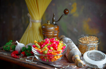 Pasta, spaghetti in a plate with seasonings and vegetables. Hot, natural and tasty dish.