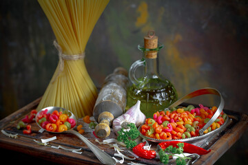 Raw pasta, spaghetti in a plate with seasonings and vegetables. Raw, ready-to-cook dish.
