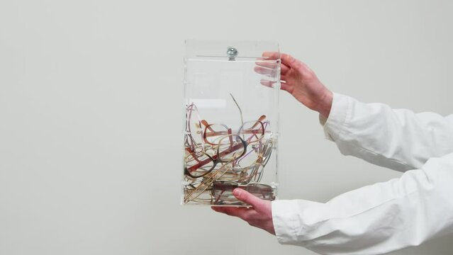 Glasses thrown into the box, enhancements, vision correction and eye optics. The concept of not needing glasses, eye surgery, and improving vision.