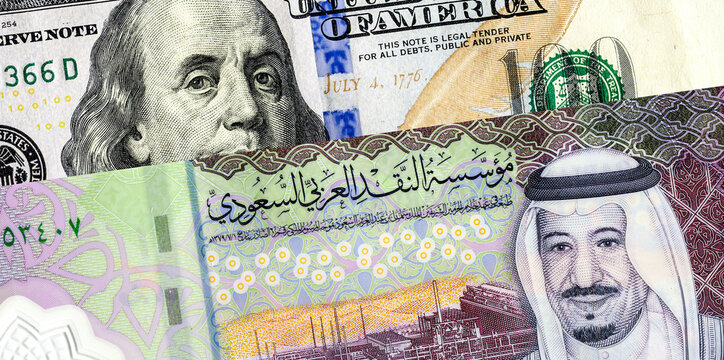 Saudi Arabia banknote with King Salman and American dollars banknote with Benjamin Franklin. Business concept of the exchange rate, stock exchange