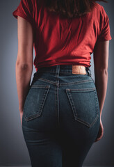 young woman in jeans and red jacket.
