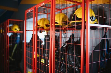 Helmets and uniforms in locker room of fire fighters