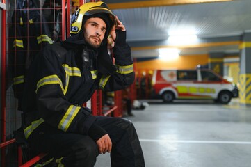 Portrait of male firefighter in uniform at fire station