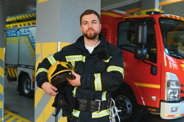 Portrait of male firefighter in uniform at fire station