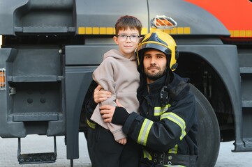 Firefighter holding child boy to save him in fire and smoke,Firemen rescue the boys from fire