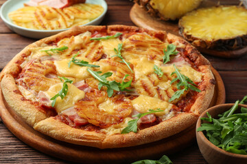 Delicious pineapple pizza with arugula on table, closeup
