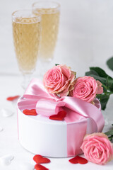 Beautiful surprise greeting for saint Valentine's or Women's Day, birthday or Anniversary for beloved. Fresh pink roses, gift box with sweets. White background. Holiday atmosphere