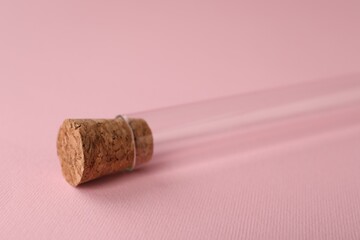 Fototapeta na wymiar Test tube on pink background, closeup. Laboratory glassware