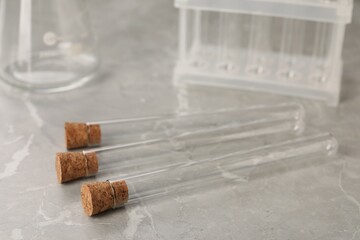 Test tubes on grey marble table, closeup. Laboratory glassware