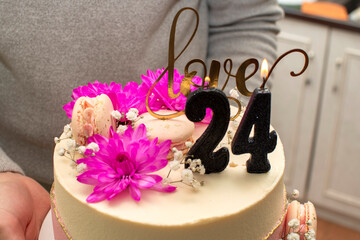 Close up view of birthday cake with 24th birthday numeral candle