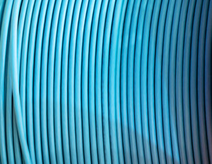 A coil of blue electrical cable close-up