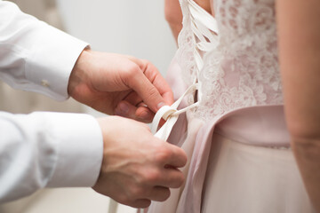 Obraz na płótnie Canvas Bride and Groom Holding Hands in Wedding Ceremony