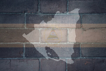 map and flag of nicaragua on a old brick wall