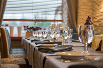 Luxurious restaurant setting with wine glasses and refined decor.