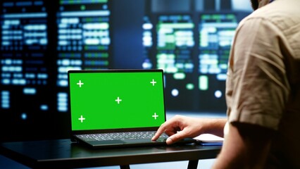 Computer scientist monitoring mainframes doing intense computations. Programmer using green screen...