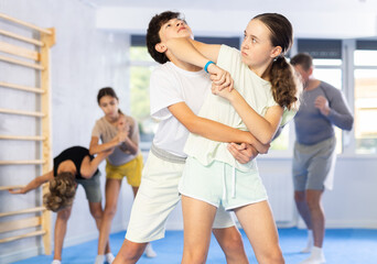 Pupils train to perform defense by jowl thrust opponent, while learning self-defense techniques....