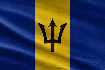 Realistic photo of Barbados flag. Barbados flag with big folds waving close up under the studio light indoors. The official symbols and colors in fabric banner