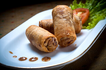 Picture of Risoles spring rolls filled with vegetables, typical Indonesian snack menu, taking pictures with decoration and artistic value, food photography