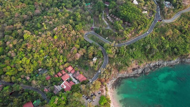 A serpentine road near Yanui beach at Phuket island, Thailand. Aerial drone footage 4k vibrant in sunny weather