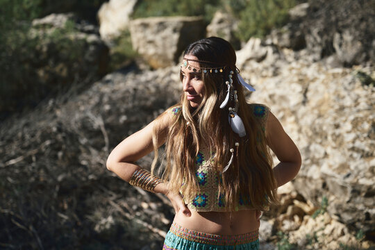 Boho woman shielding eyes outdoors
