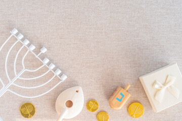 Menorah, wooden dreidels, pitcher of olive oil, chocolate coins, gift box for Jewish holiday...