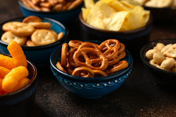 Salty snacks crackers, potato chips, pretzel, peanuts, corn puffs.