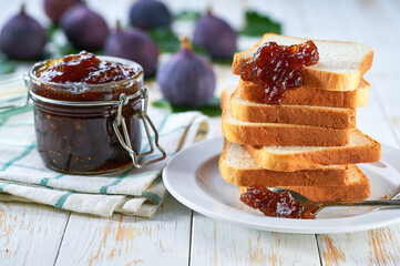 figs jam sandwiches or toasts on light wooden background.