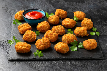 Potato croquettes with ham and cheese on stone board