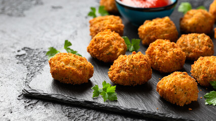 Potato croquettes with ham and cheese on stone board