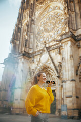 woman listening to audio guide app, talking on phone and walking