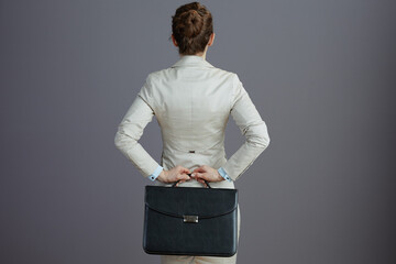 Seen from behind business owner woman in light business suit