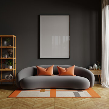 Orange pillow on dark grey sofa in modern apartment interior with poster and accessories decoration