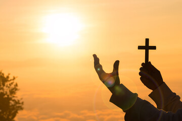 Silhouette of prayer woman worship God in the morning with sunrise sky background. Christian Religion concept. Person hands open palm up worship. God helping repent catholic easter lent mind pray.