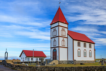 beautiful red and white Kálfatjarnarkirkja Church in the Reykjavik peninsula -- built in 1893 and...