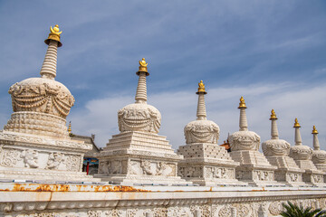 A row of white in Hohhot, Inner Mongolia. The stupas are richly decorated