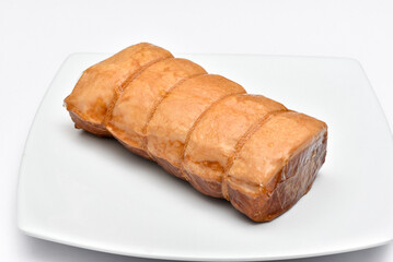 Smoked Pork meat, isolated on white background, Whole ham, carved with a butchers knife. Lunch or dinner favorite, meat ideal for sandwiches or served with vegetables.
