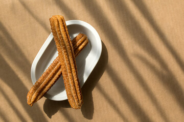 Flour churros with sugar and cinnamon in Mexico with space for text on the right