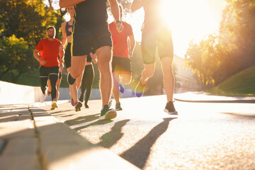 Group of people running outdoors on sunny day © New Africa