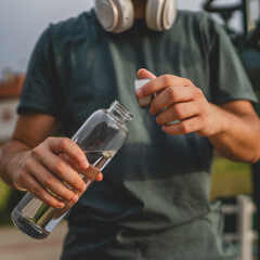 man young male teenager hold bottle of water drink training outdoor