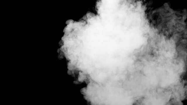 White fog or smoke on dark copy space background in slow motion. Cloud of cold fog in light spot, ice smoke cloud. Animated realistic video concept. 2d 4k animation with alpha channel