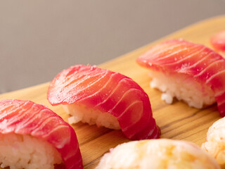 Raw salmon sushi on cutting board