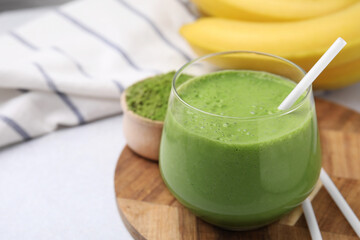 Glass of tasty matcha smoothie on white table, closeup. Space for text